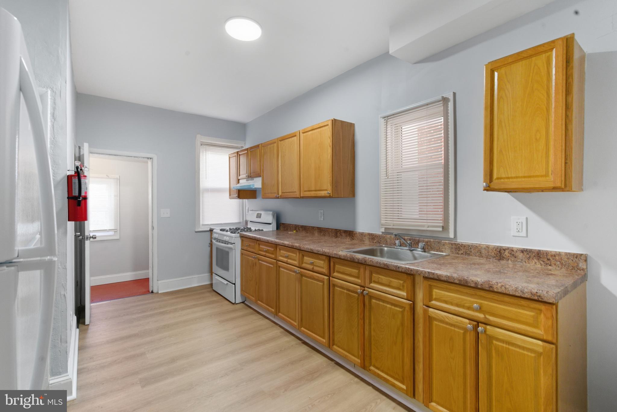 5632 Addison Street Philadelphia, PA 19143 - Photo 7 of 14 a kitchen with stainless steel appliances granite countertop a sink and cabinets