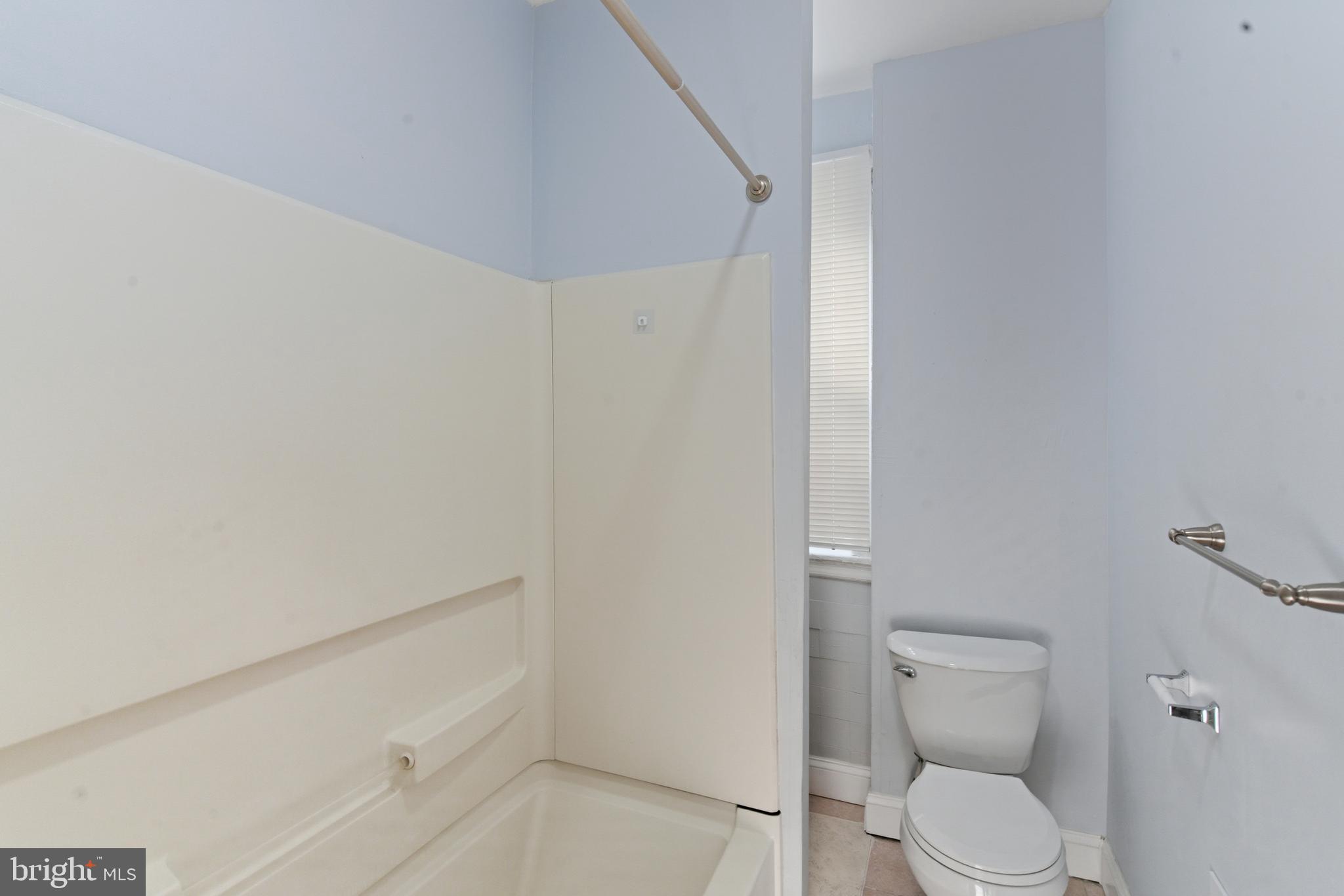 5632 Addison Street Philadelphia, PA 19143 - Photo 8 of 14 a white toilet sitting next to a shower