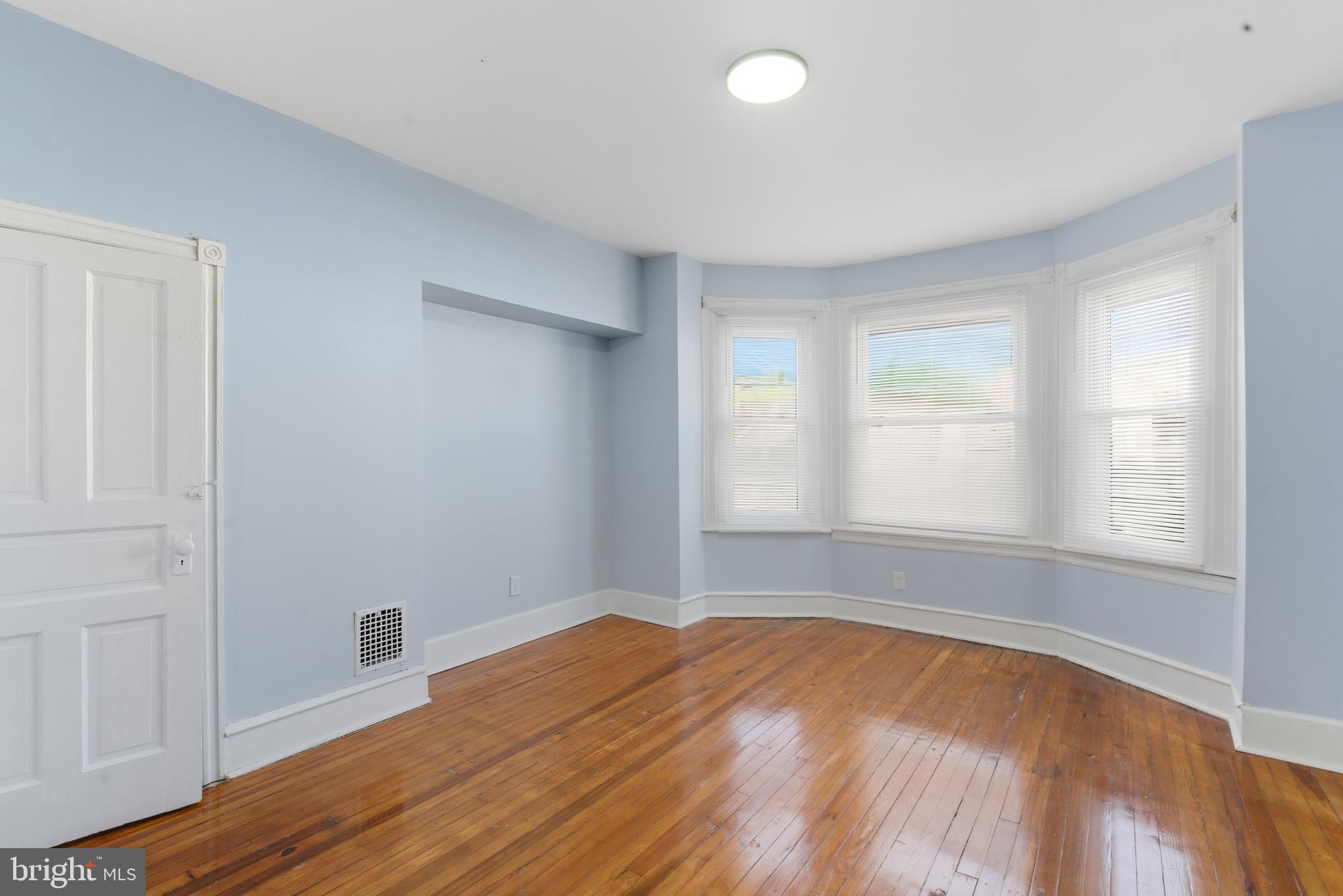5632 Addison Street Philadelphia, PA 19143 - Photo 9 of 14 an empty room with wooden floor and windows
