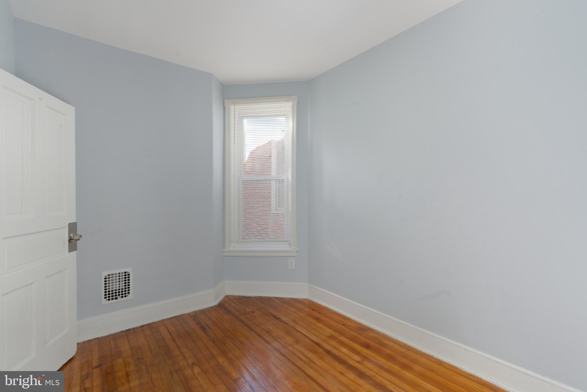 5632 Addison Street Philadelphia, PA 19143 - Photo 10 of 14 a view of an empty room with wooden floor and a window