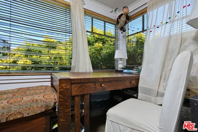 a bedroom with furniture and a book shelf