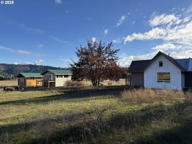 a view of a house with a yard next to a lake