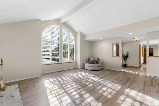 a kitchen with stainless steel appliances a refrigerator a sink and white cabinets