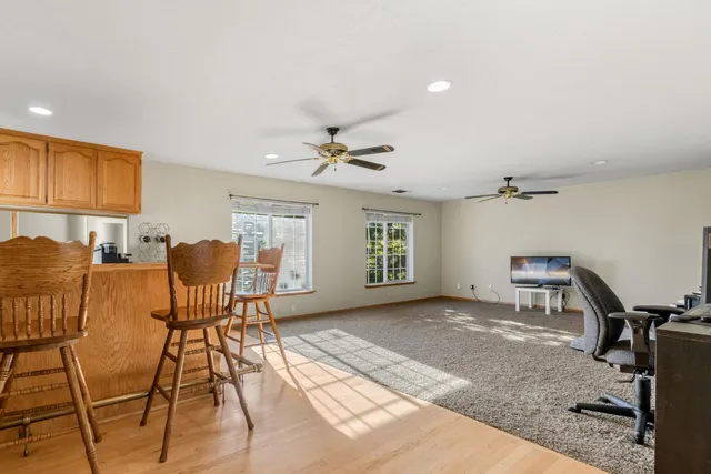 a bedroom with a bed a large window and a potted plant