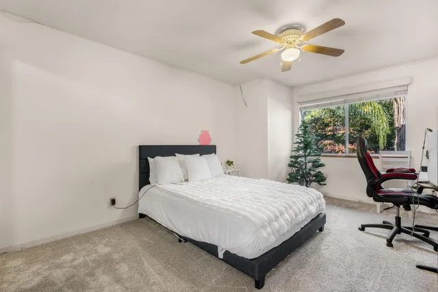 a view of a room with a ceiling fan