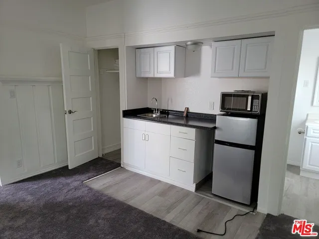 a kitchen with stainless steel appliances granite countertop a refrigerator sink and stove