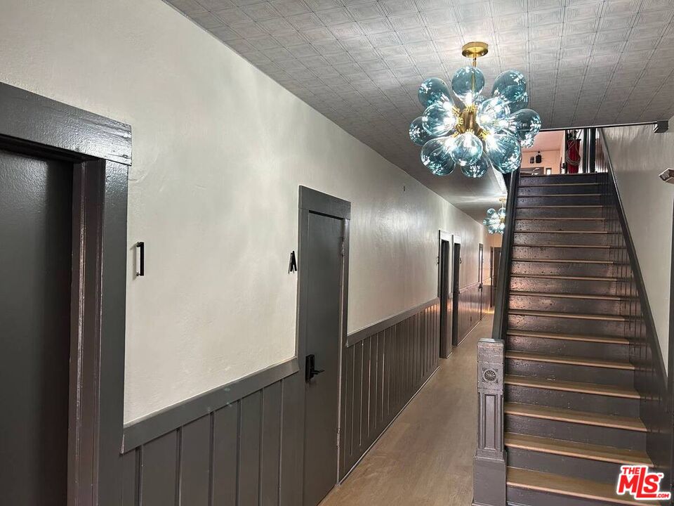 125 North Broadway, Unit 3 Redondo Beach, CA 90277 - Photo 10 of 12 a view of a hallway with wooden floor and chandelier
