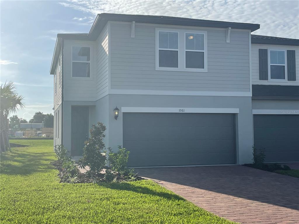 1061 Desert Candle Drive Ocoee, FL 34761 - Photo 1 of 1 a front view of a house with garden