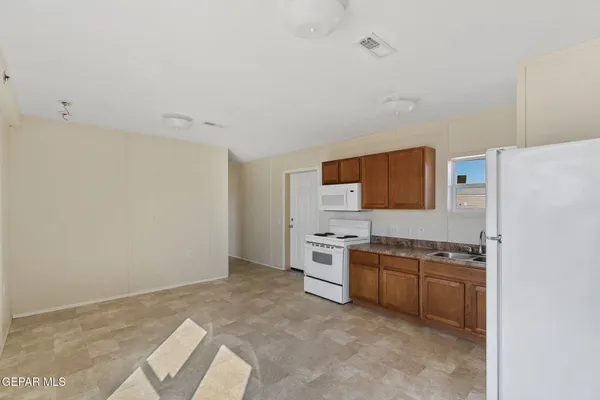 a dining room with furniture a window and kitchen view