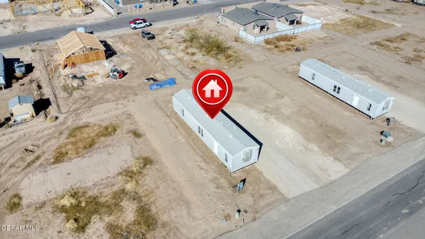 a bed with white sheets and pillows on it