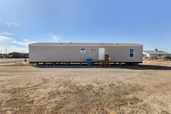 a view of a kitchen with refrigerator and white cabinets