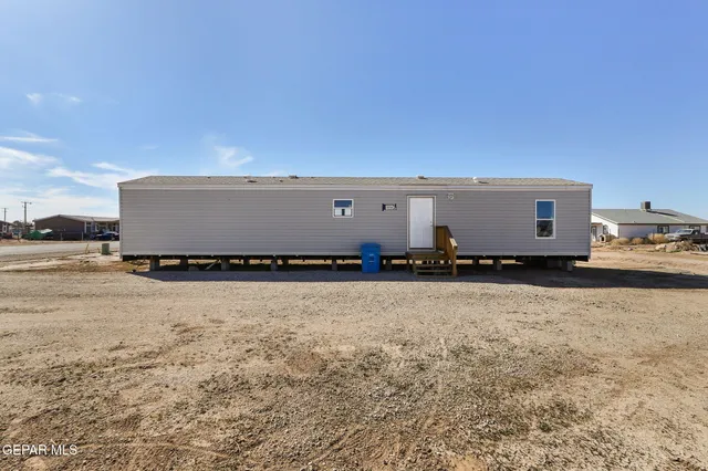 a view of a kitchen with refrigerator and white cabinets
