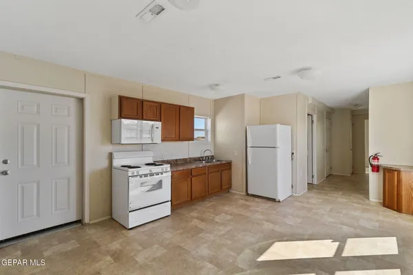 a kitchen with a refrigerator sink stove and cabinets