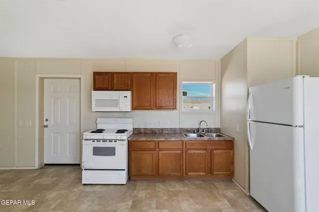 a kitchen with a refrigerator sink stove and cabinets