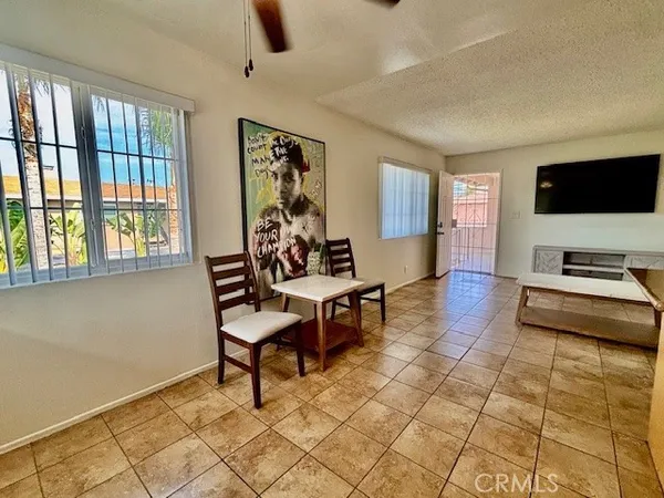 a living room with furniture a flat screen tv and a table