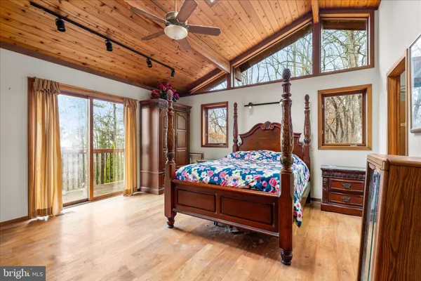 a bedroom with a bed window and a chandelier