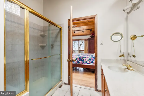 a bathroom with a tub sink and mirror