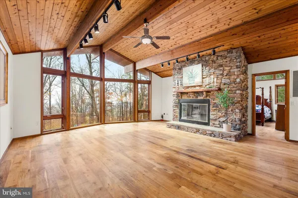 a view of an empty room with a fireplace and a window