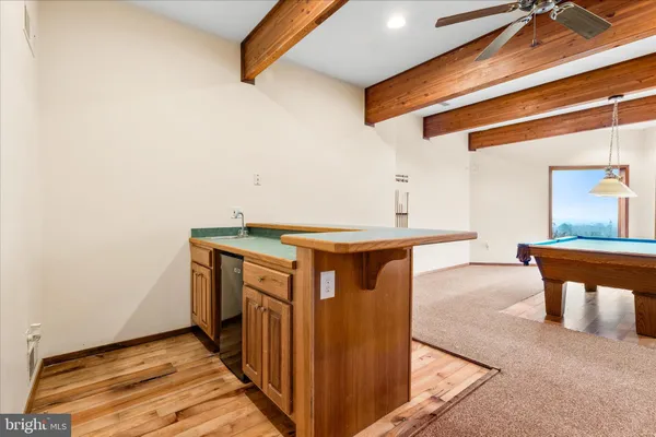 a room with furniture pool table and window
