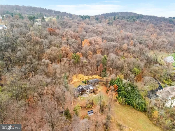 a view of a house with a big yard next to a building