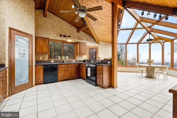 a kitchen with stainless steel appliances kitchen island granite countertop a refrigerator stove and sink