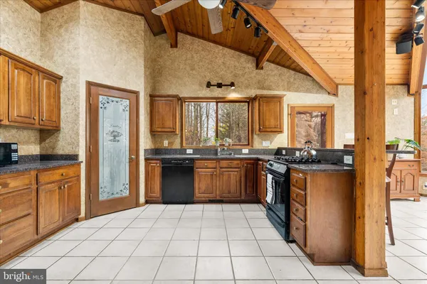 a large kitchen with stainless steel appliances granite countertop a stove and a sink