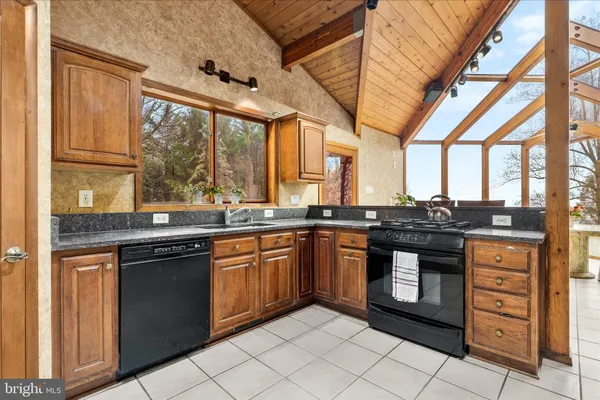 a kitchen with stainless steel appliances granite countertop a stove and a sink