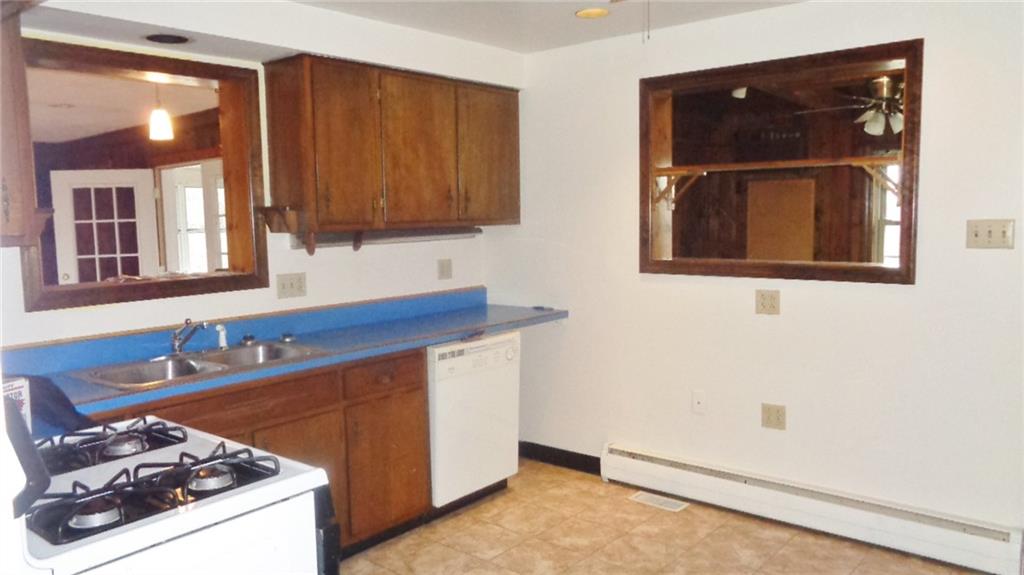 5545 Glass Road Pittsburgh, PA 15205 - Photo 15 of 18 KITCHEN. Good-sized room. Pass throughs to Family Room and Den. Vinyl flooring. Stainless Sink. Dishwasher. Gas Stove.