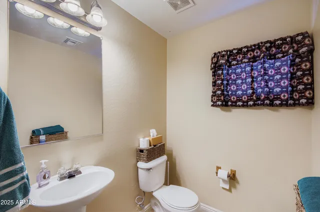 a white toilet sitting next to a bathroom sink