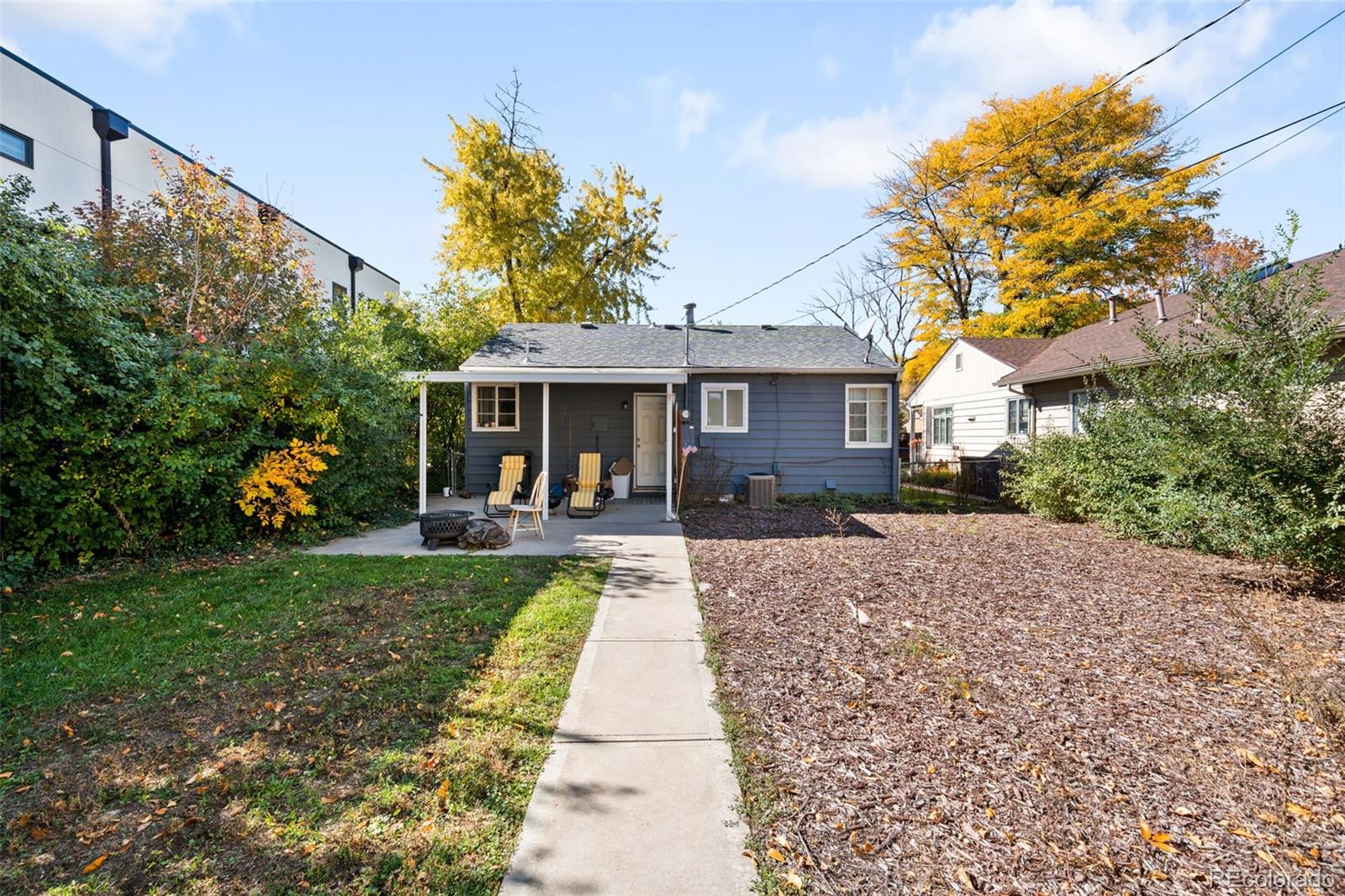 2664 South Cook Street Denver, CO 80210 - Photo 9 of 13 a view of a house with a yard