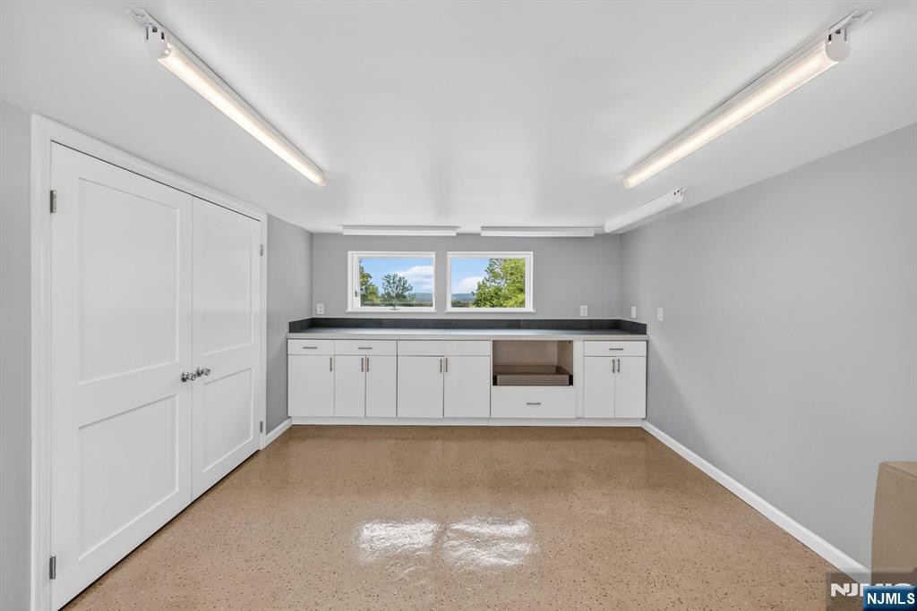57 Hemlock Road Little Falls, NJ 07424 - Photo 38 of 50 a kitchen with white cabinets and a window