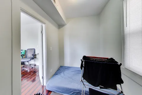 a view of bedroom with wooden floor