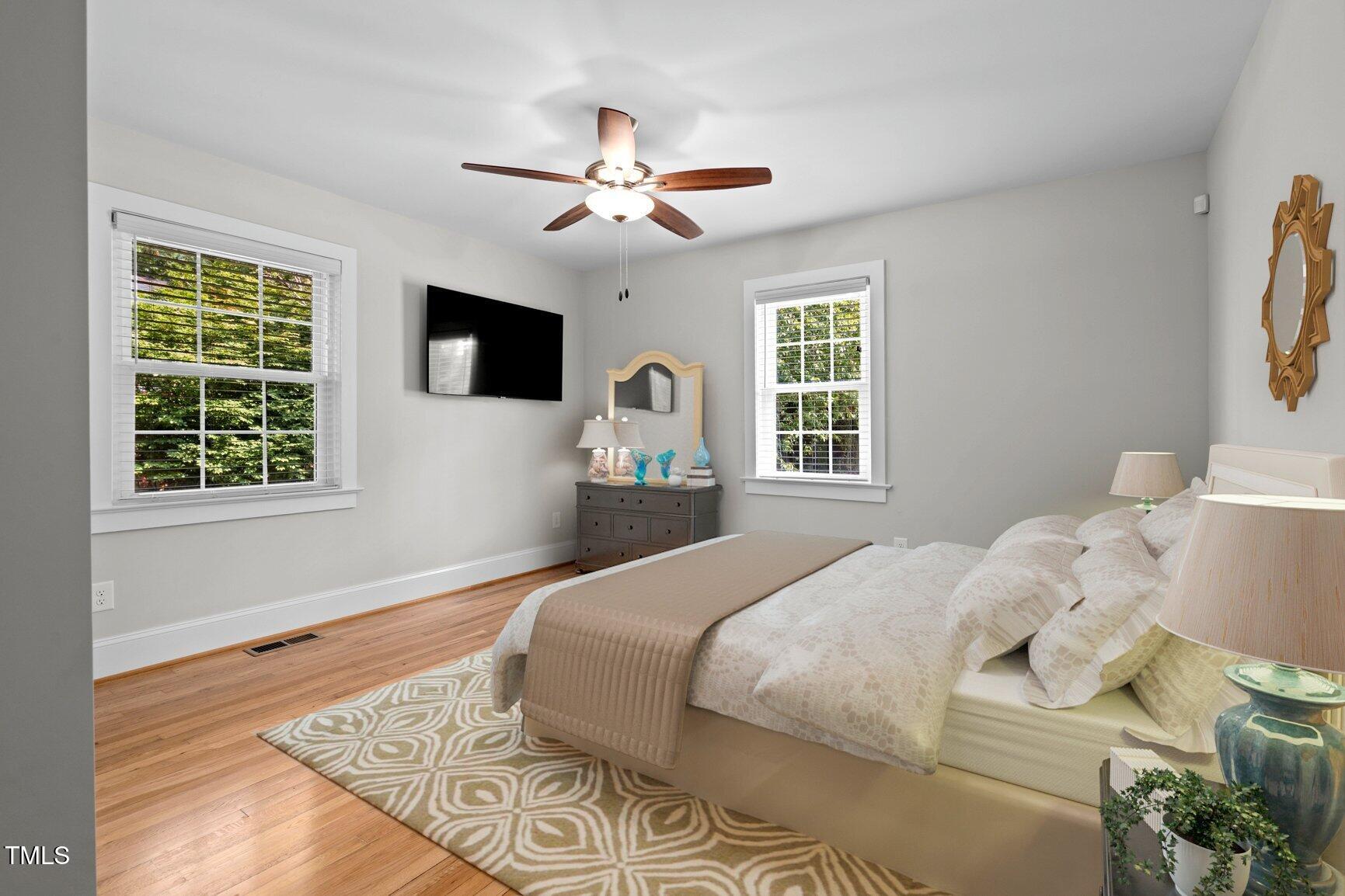 216 Whitfield Street Enfield, NC 27823 - Photo 18 of 31 a bedroom with a bed and a flat screen tv
