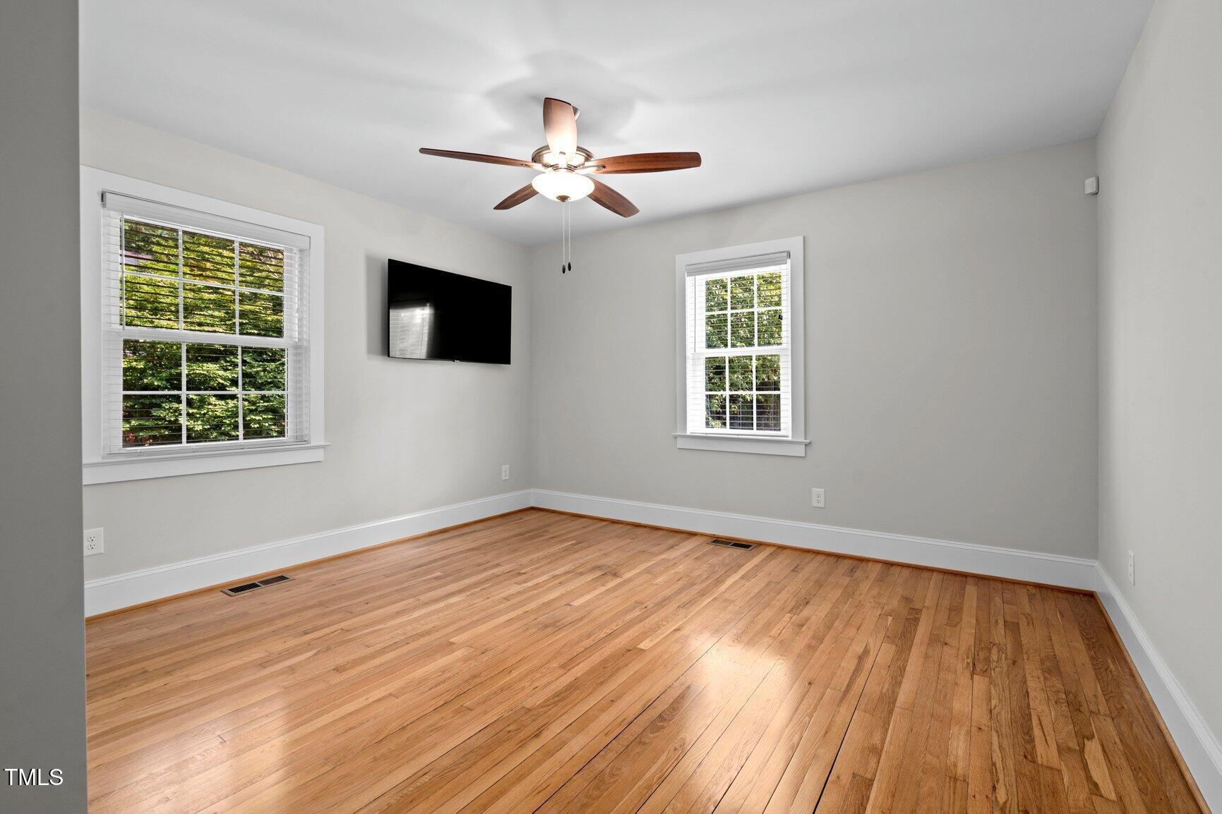 216 Whitfield Street Enfield, NC 27823 - Photo 19 of 31 a view of empty room with wooden floor and fan