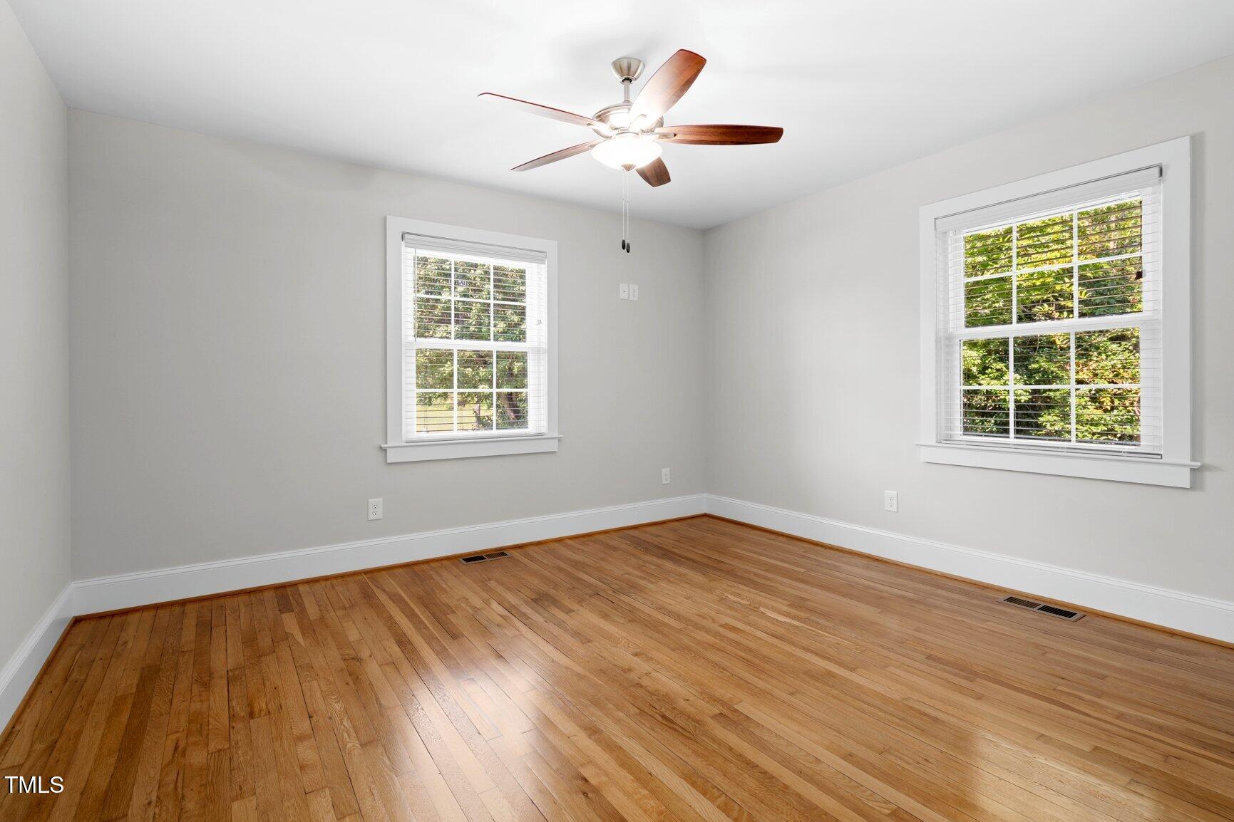 216 Whitfield Street Enfield, NC 27823 - Photo 20 of 31 a view of an empty room with wooden floor and a window