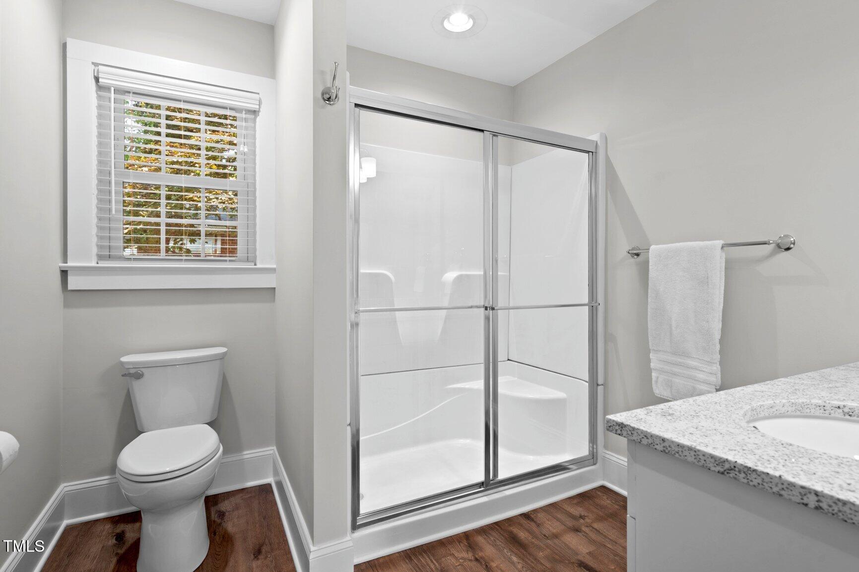 216 Whitfield Street Enfield, NC 27823 - Photo 23 of 31 a bathroom with a granite countertop sink toilet and shower
