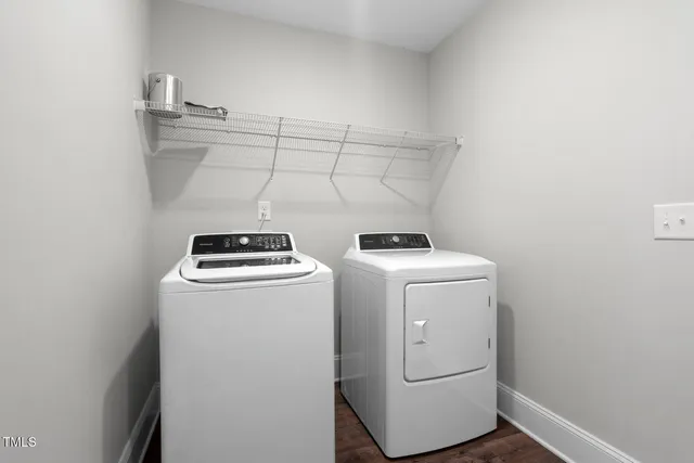 a bathroom with a sink and mirror with wooden floor