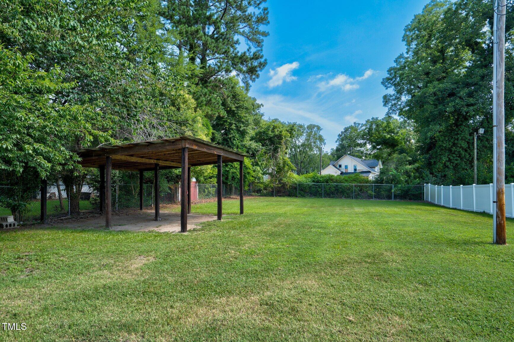 216 Whitfield Street Enfield, NC 27823 - Photo 28 of 31 a backyard of a house with table and chairs