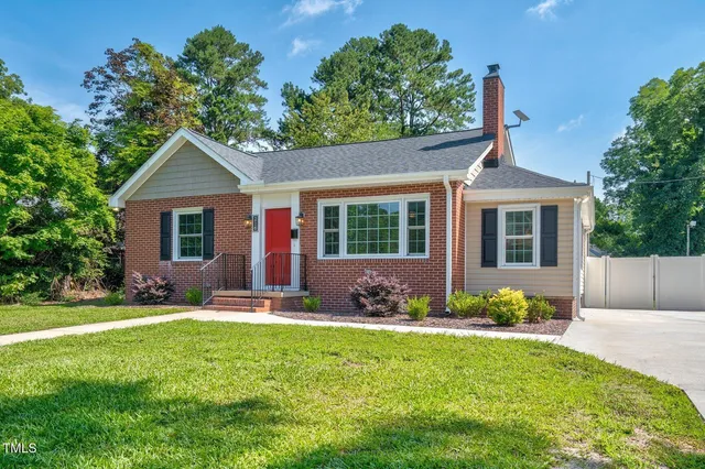 a view of a backyard with a slide and large trees