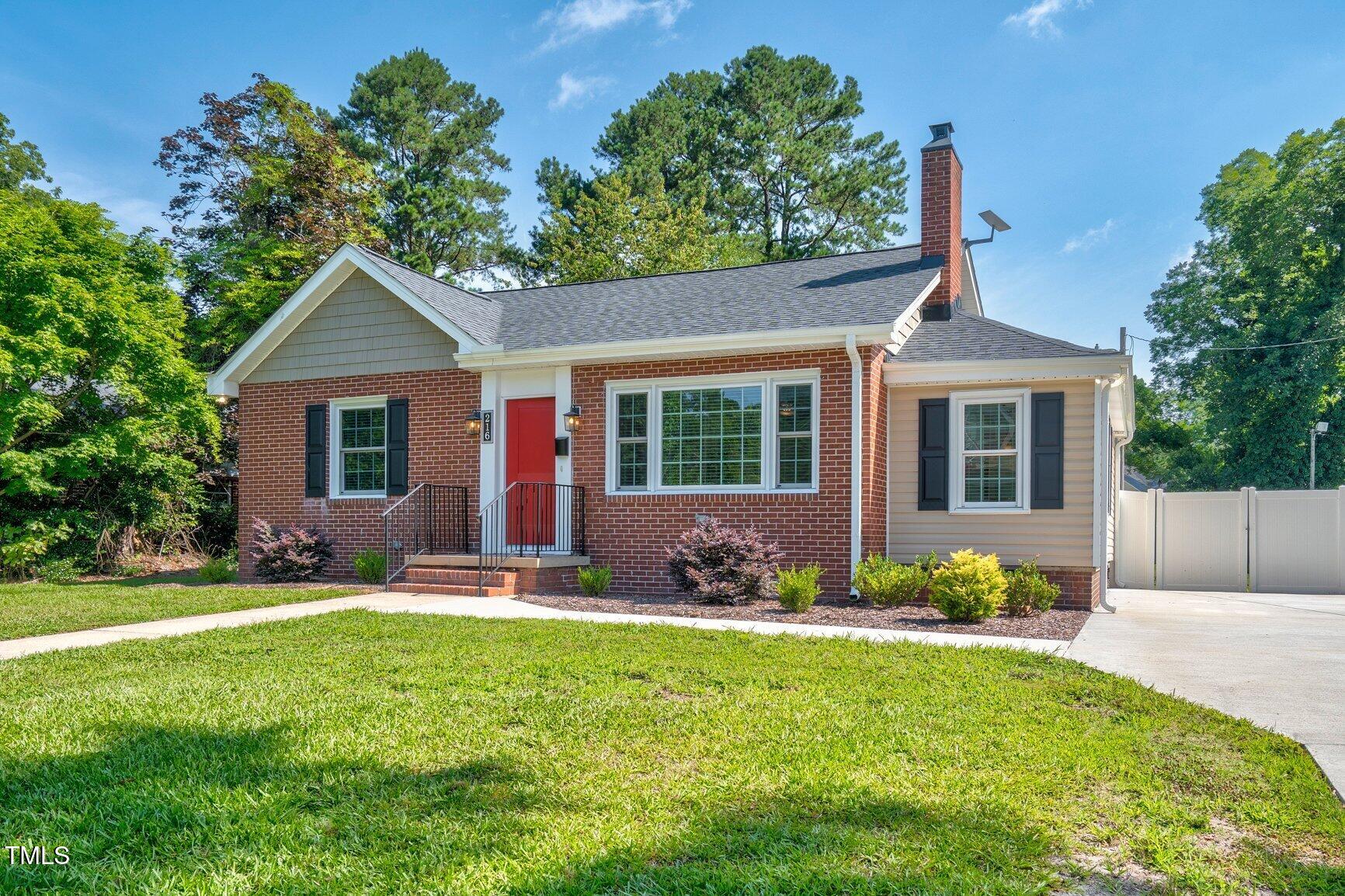 216 Whitfield Street Enfield, NC 27823 - Photo 30 of 31 a front view of a house with garden