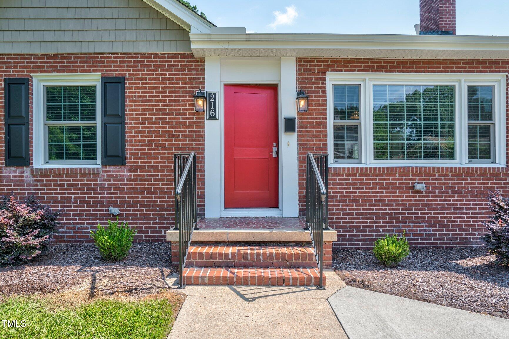216 Whitfield Street Enfield, NC 27823 - Photo 3 of 31 a brick house with a small yard