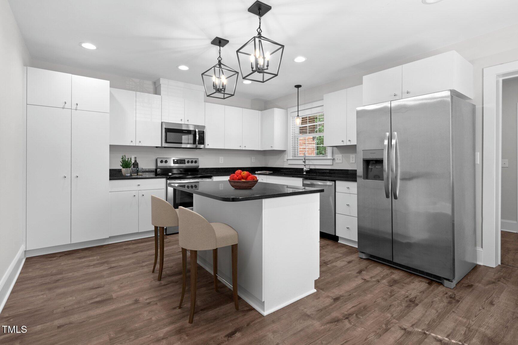 216 Whitfield Street Enfield, NC 27823 - Photo 9 of 31 a kitchen with stainless steel appliances a refrigerator a stove a sink and chairs