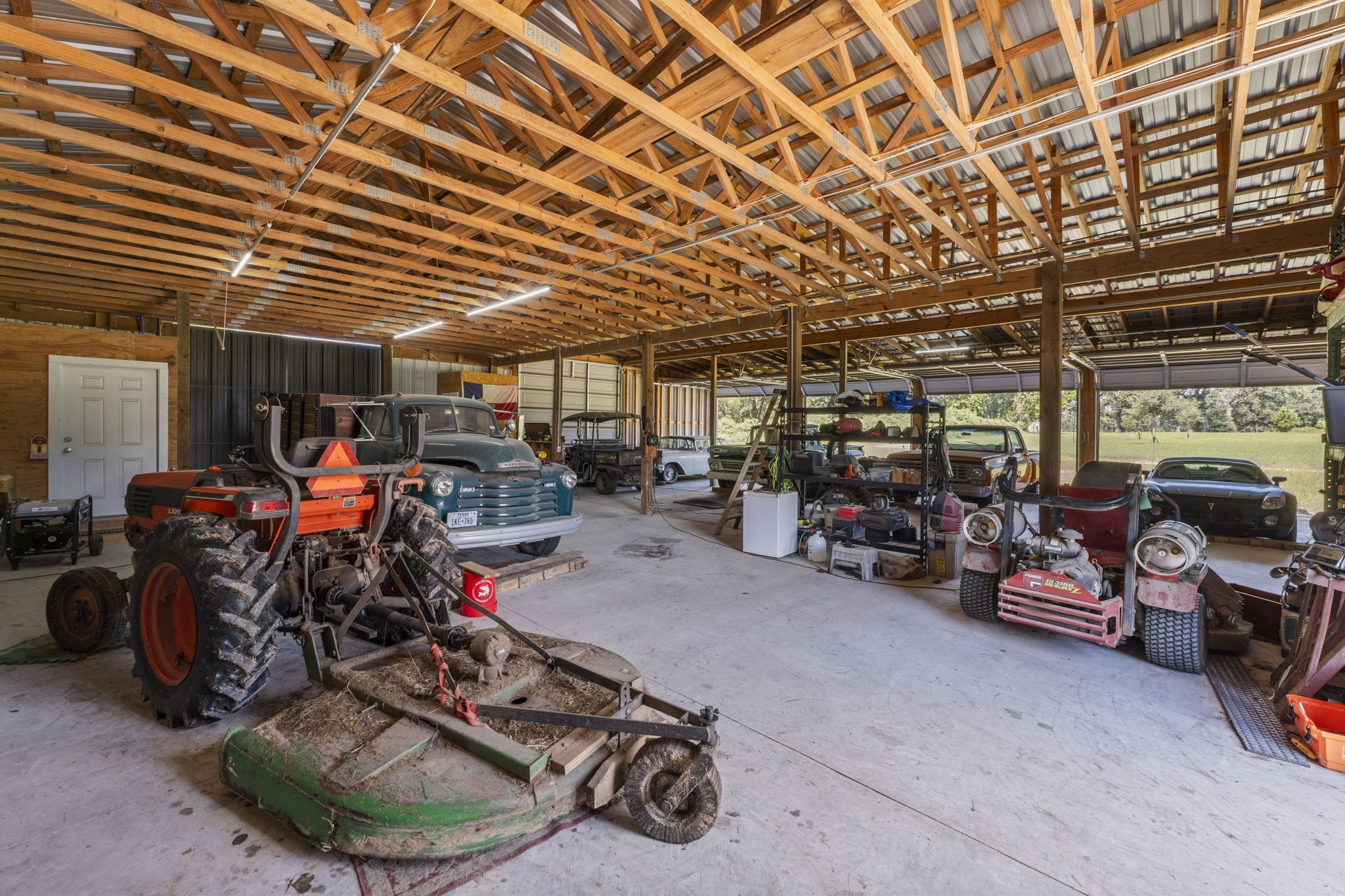 1534 Virgie Community Road Magnolia, TX 77354 - Photo 46 of 50 The interior of the workshop is so large you can have several projects going at once. Store farm equipment, classic cars and projects with ease! This building features 4 large bays and two high sliding entrance doors for easy access from all sides.