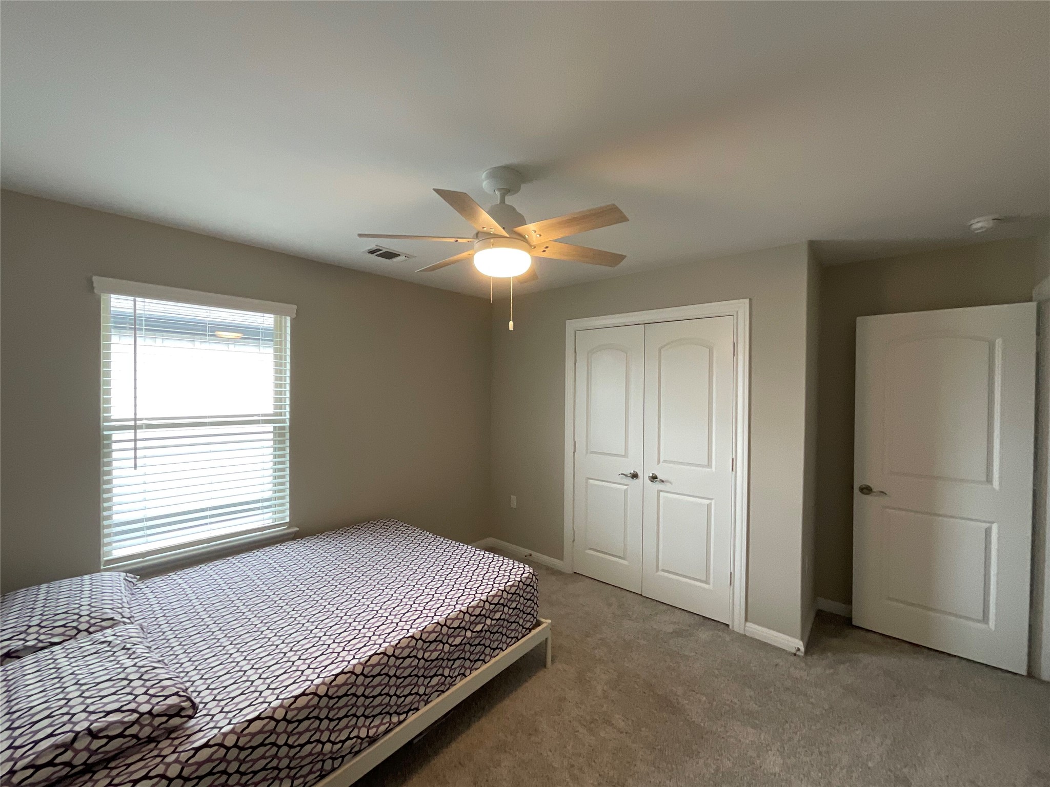 5425 Durango Pass Austin, TX 78724 - Photo 10 of 32 Bedroom featuring a french door closet, and ceiling fan