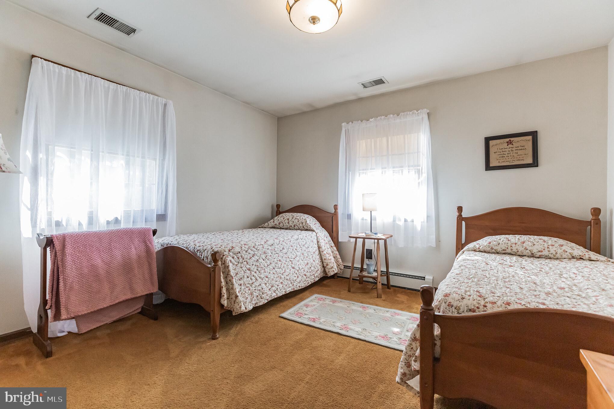 220 Robinson Road Salem, NJ 08079 - Photo 14 of 23 a bedroom with a bed and a lamp with window