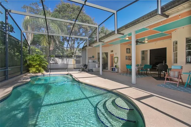 a swimming pool with outdoor seating and yard