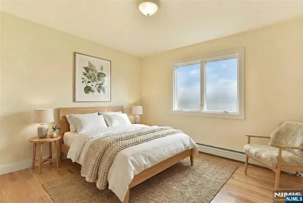 a bedroom with a bed and chair