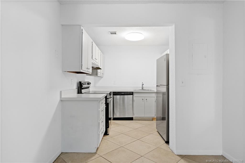 2118 Southeast Edler Drive, Unit B Stuart, FL 34994 - Photo 3 of 20 a kitchen with a sink cabinets and stainless steel appliances
