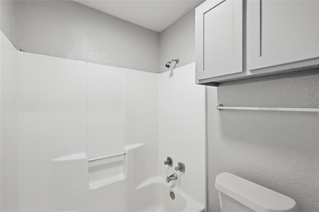 620 West Union Bower Road Irving, TX 75061 - Photo 15 of 22 Bathroom featuring a textured wall and shower / tub combination