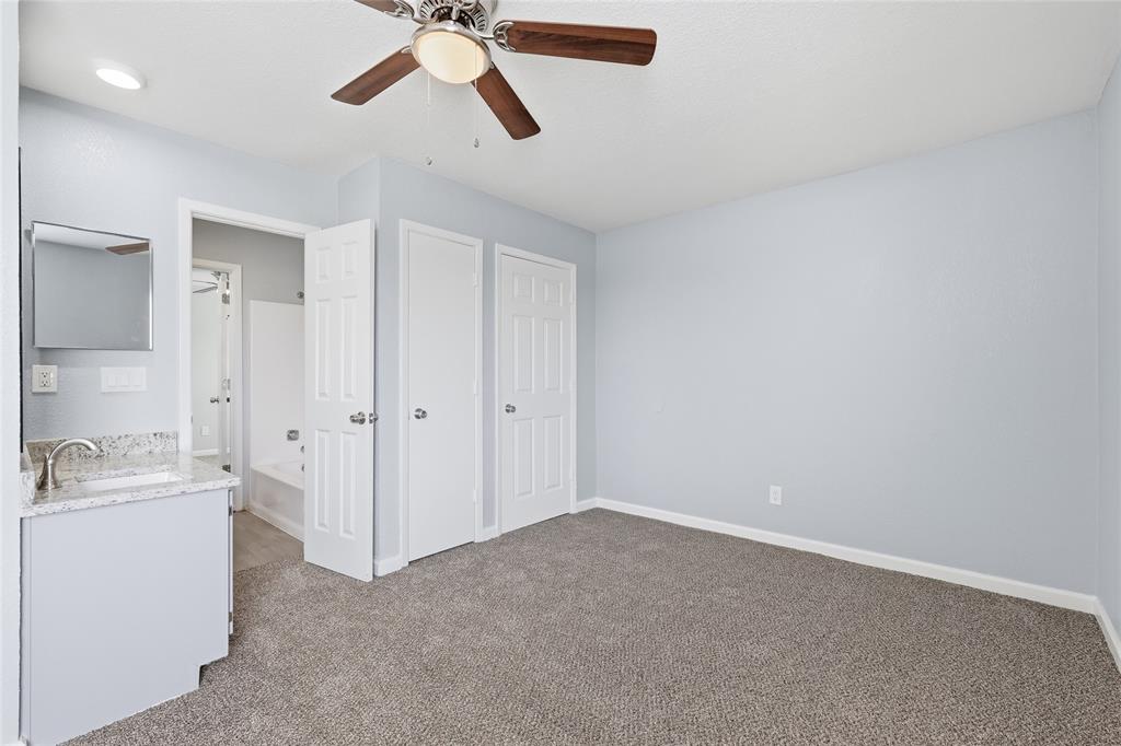 620 West Union Bower Road Irving, TX 75061 - Photo 17 of 22 Unfurnished bedroom featuring light colored carpet, ceiling fan, and ensuite bathroom